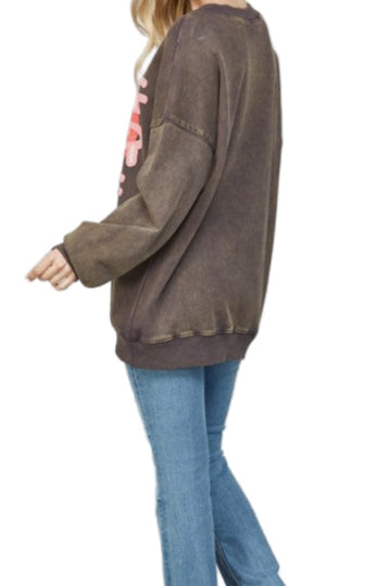 Woman wearing a brown sweater and blue jeans on a white background