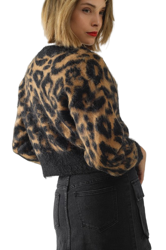 Back view of model wearing the Vivienne Leopard Knit Cardigan showing cropped fit and fluffy leopard knit texture.
