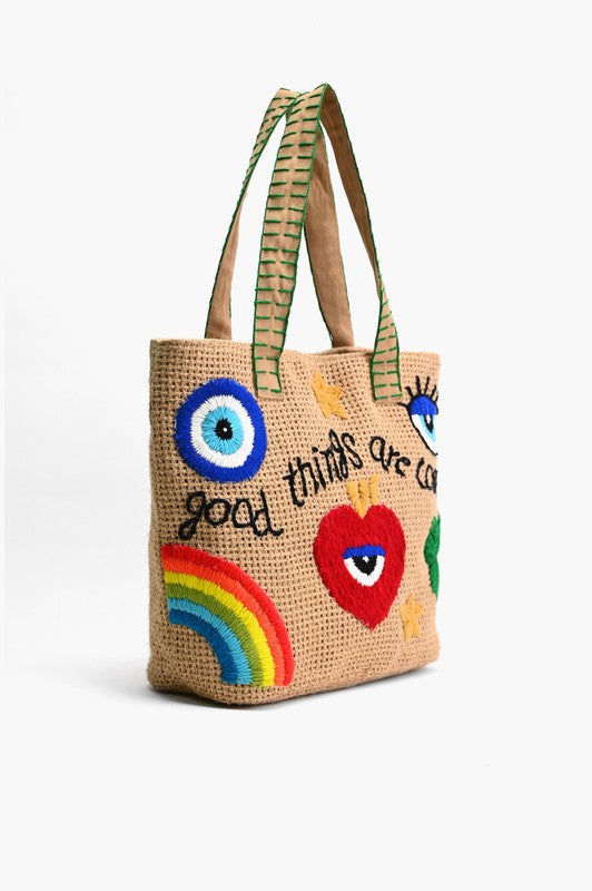 Woven tote bag with colorful designs and text on a white background