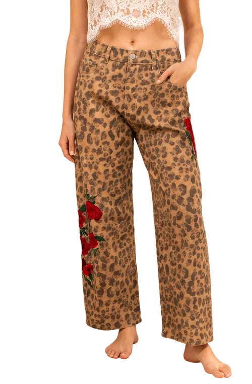 Front view of kismet + sage leopard-print barrel-leg pants with red rose embroidery