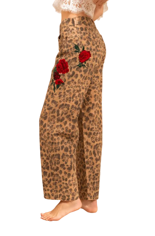 Side view of mid-rise leopard-print barrel-leg pants with embroidered roses