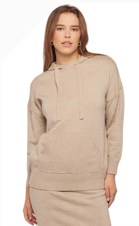 Woman wearing a beige hoodie against a white background